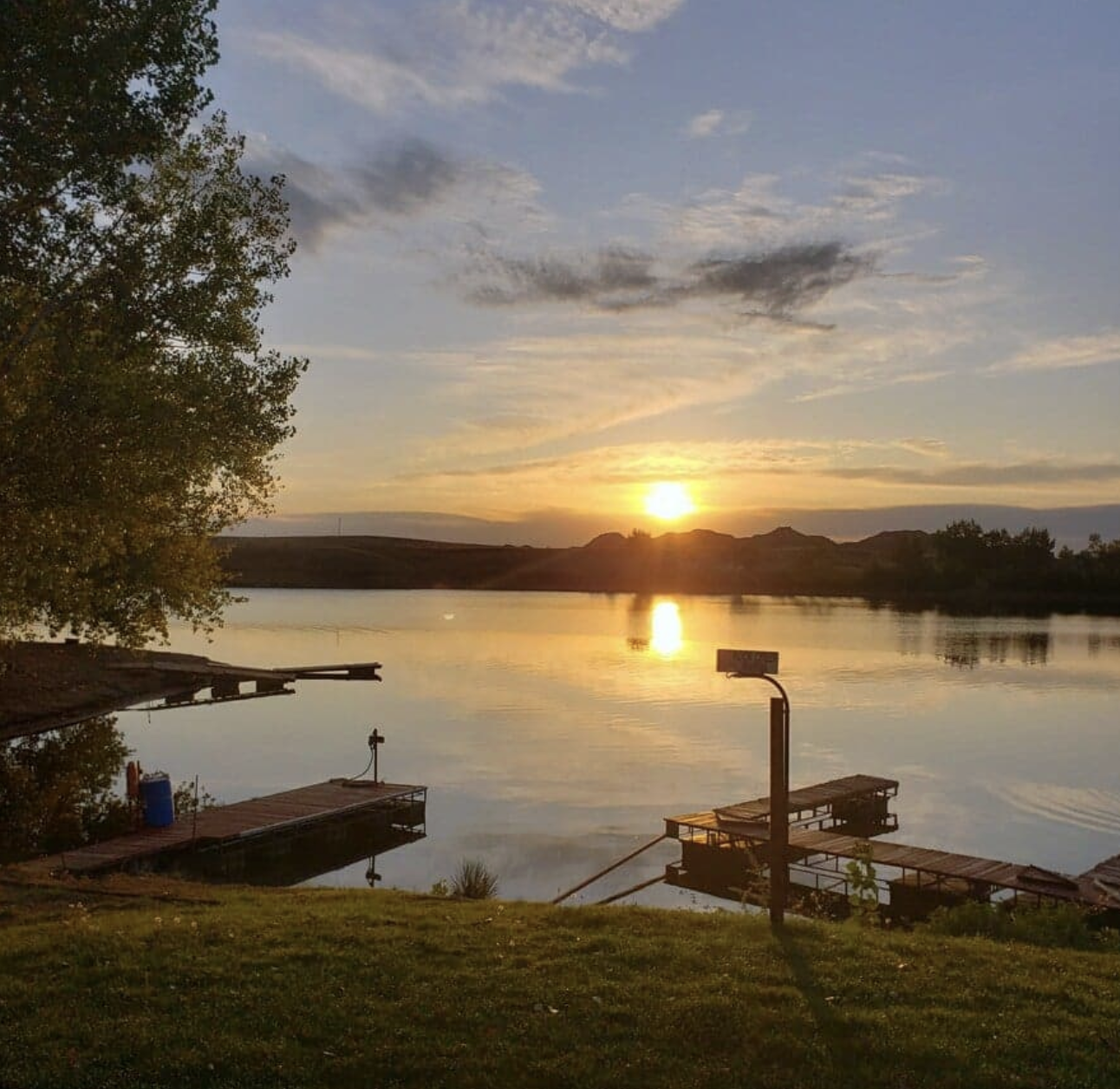 Golden sunset over Fort Peck Lake with the marina docks